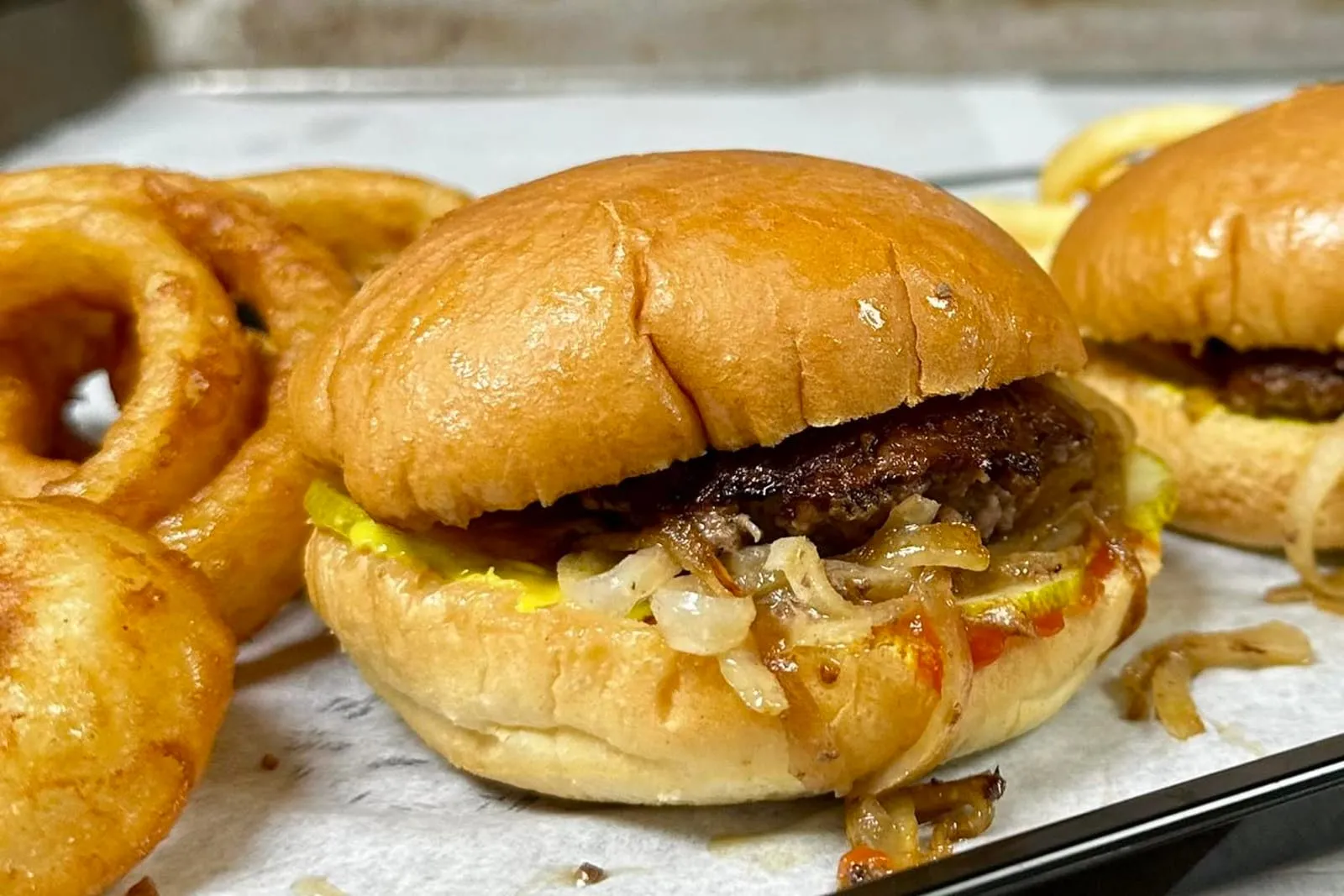 A close-up smash burger with melted cheese on a toasted bun