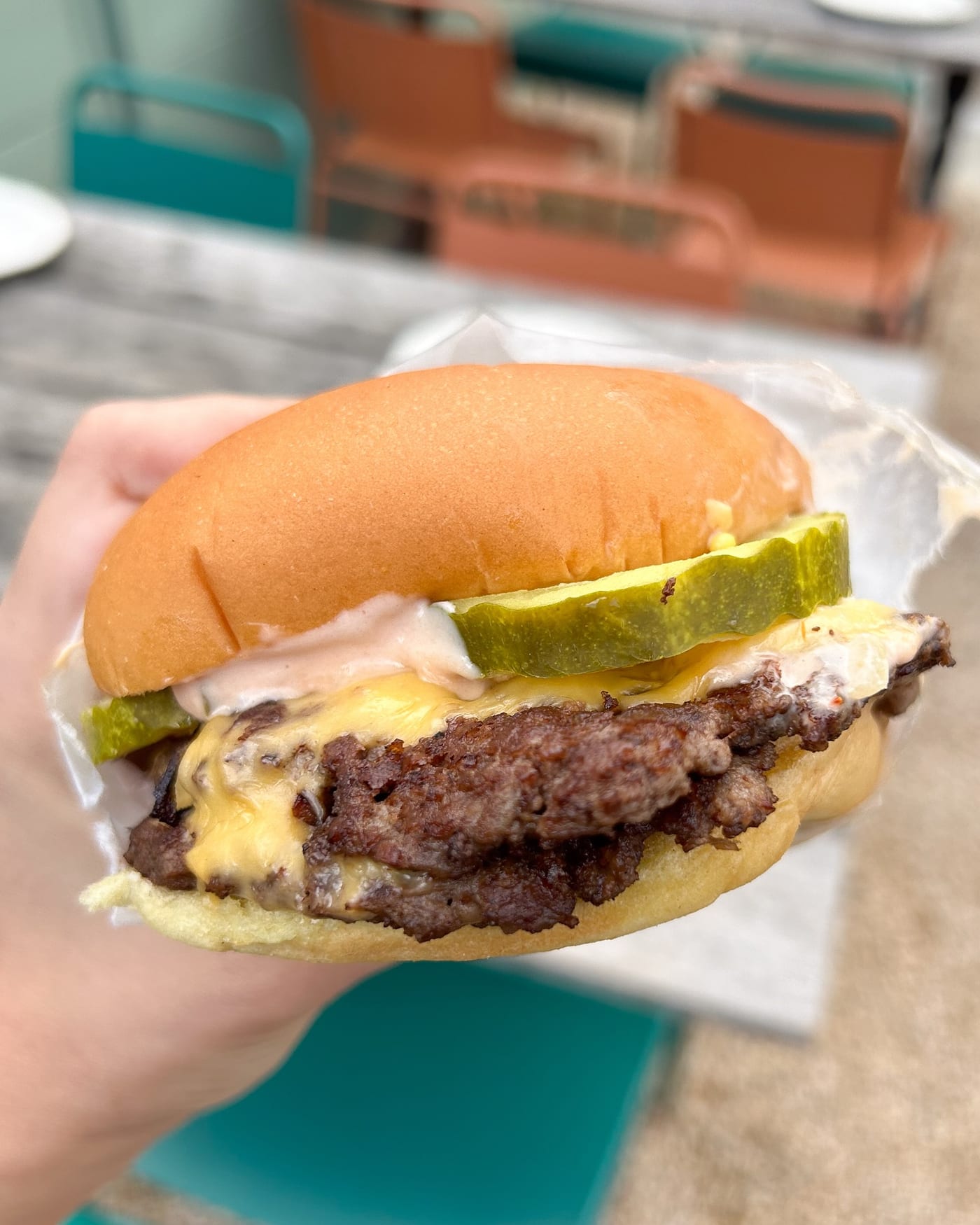 Close-up of The Win-Dow smashburger on a Martin's potato roll