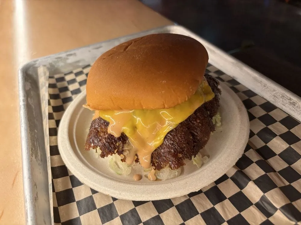 Smish Smash Cheeseboiga close-up with thin smashed patties, melted American cheese, pickles, and house sauce