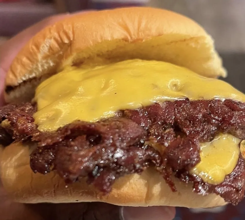 Twansburger double cheeseburger close-up with lacy beef edges and melted cheese