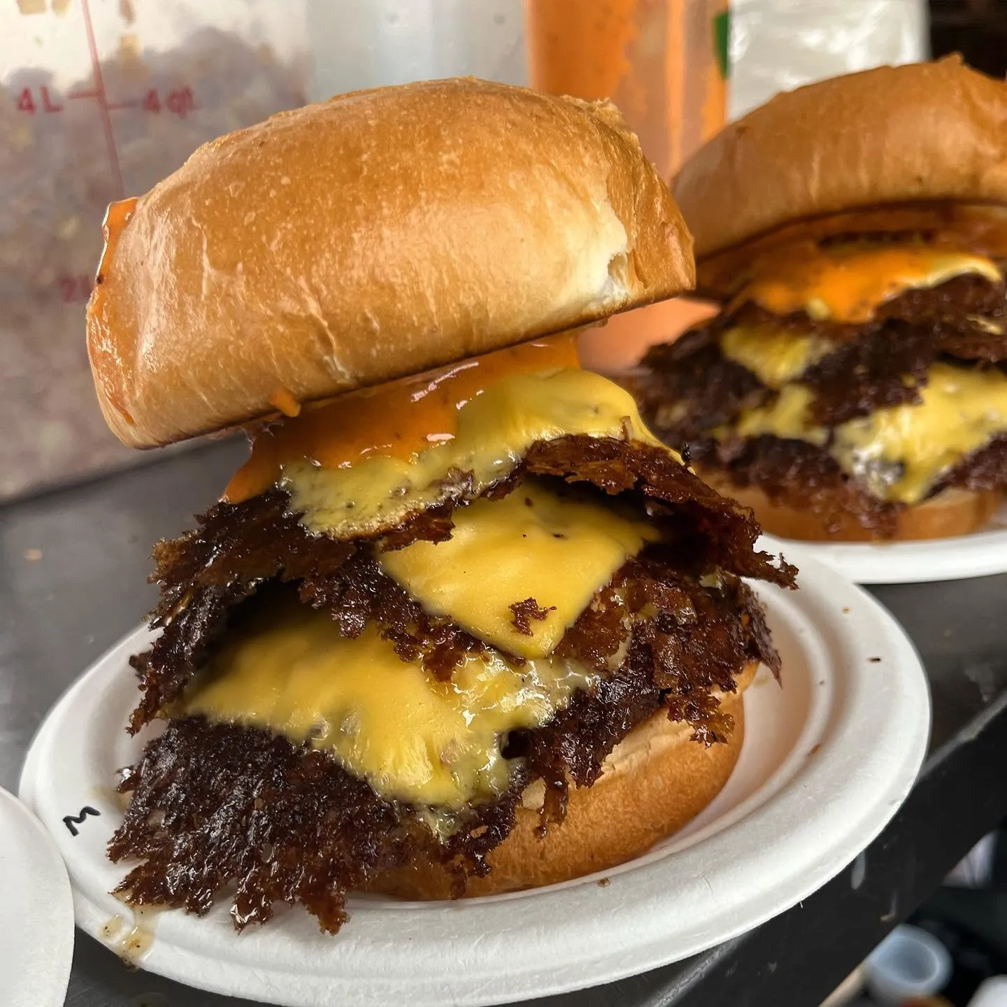 Snipeburger double smashburger with American cheese and gold sauce