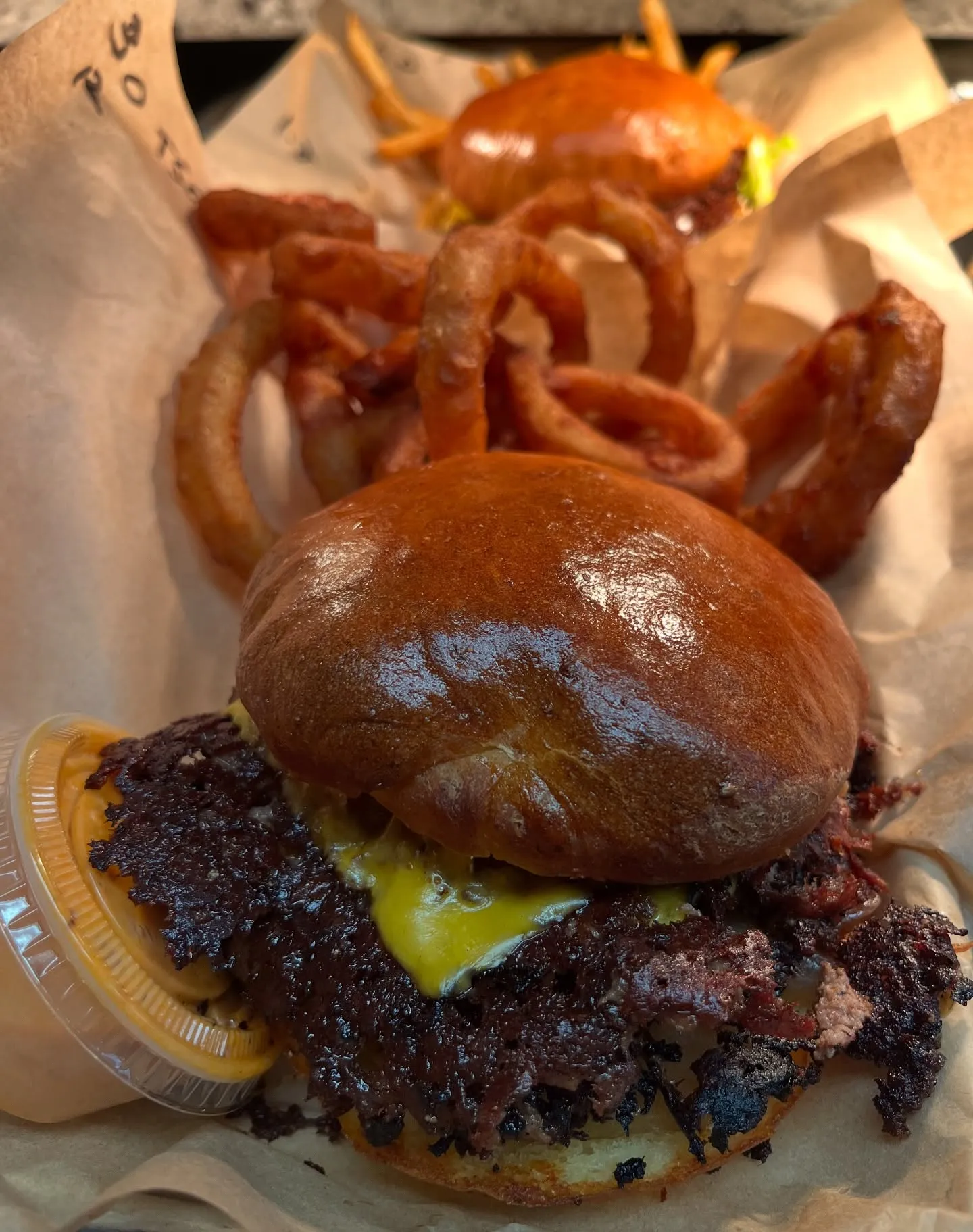 Snipeburger smashburger close-up with crisp beef edges and melted cheese