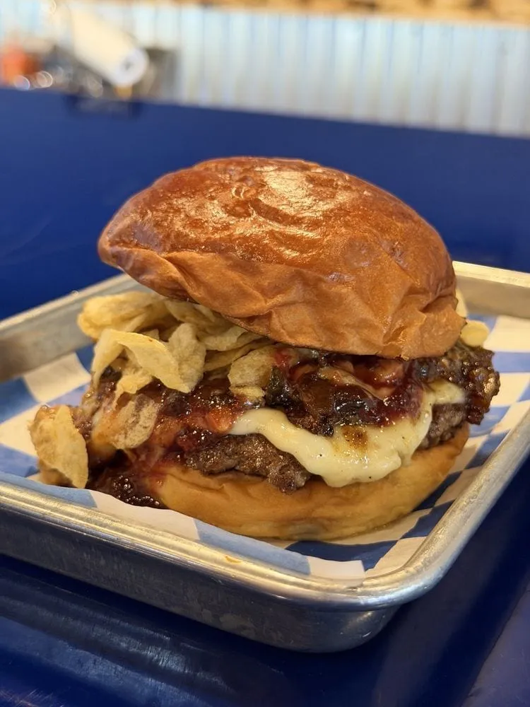 Lala's Burgers The Bacon with house-made bacon jam, pickled medley, and onion tanglers
