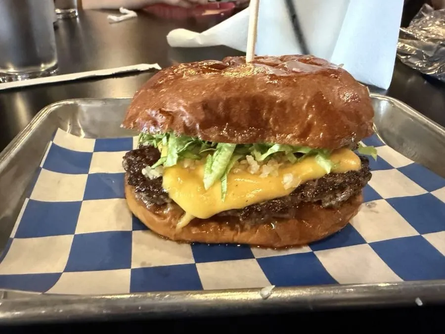 Lala's Burgers retro interior at the West Kendall location with wood paneling and collectible toys