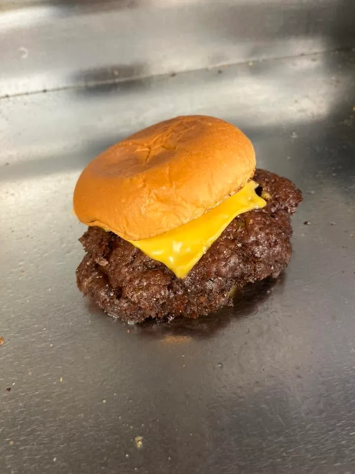 Classic smash cheeseburger on the griddle at The Midtown Burger Club in Aledo, Illinois
