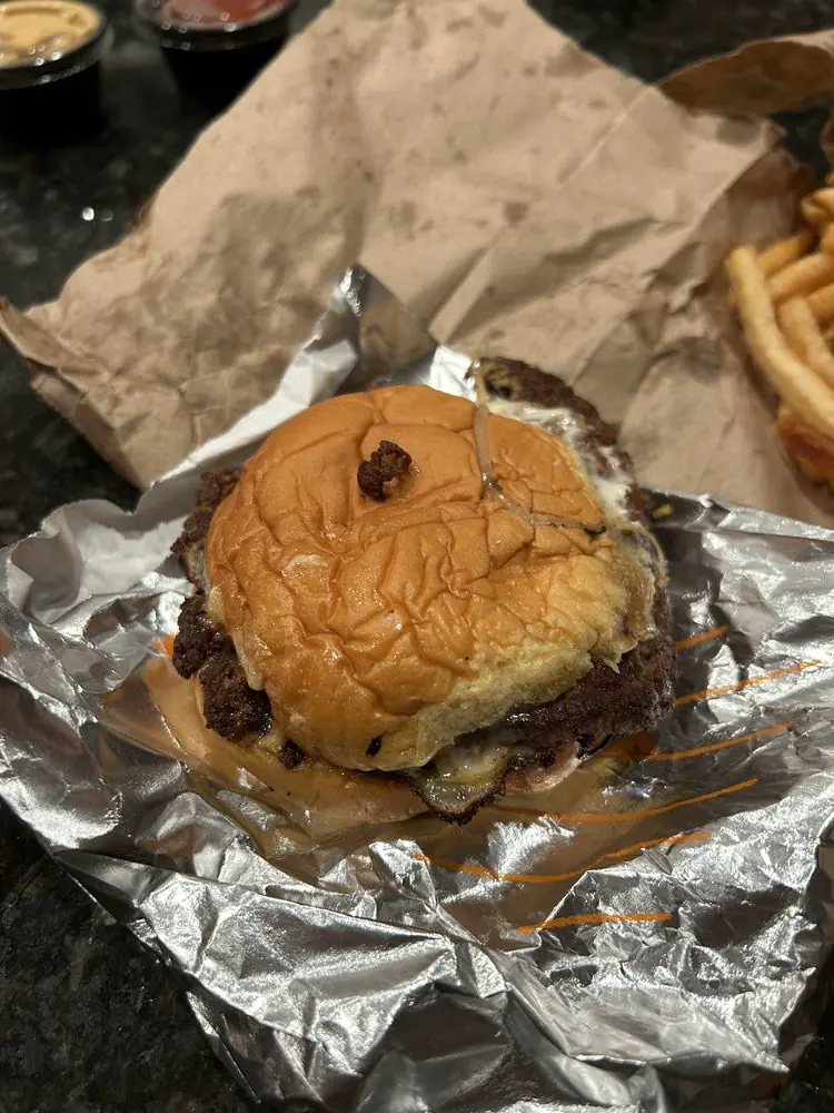 Best Intentions smashburger with single patty, white American cheese, and Dutch curry mayo on Martin's potato roll