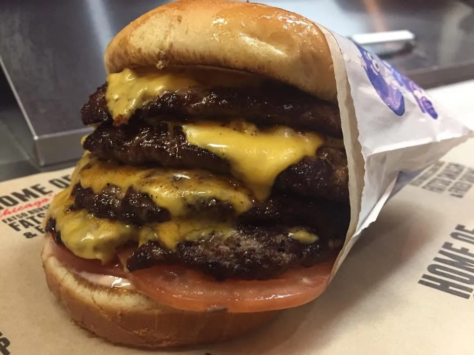 Stacked Fatso Smash patties with melted American cheese and tomato