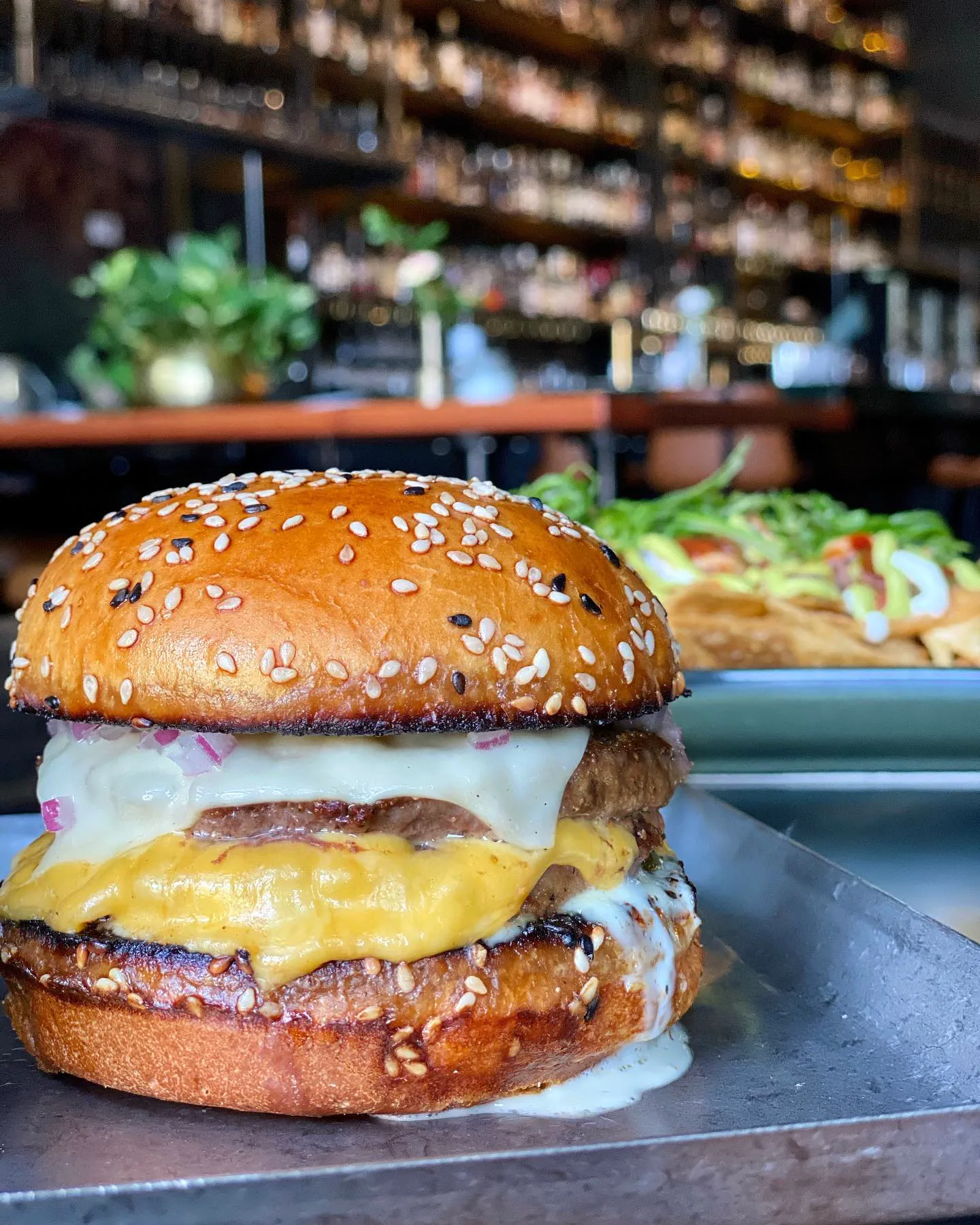 Gretel Griddle Burger with double smashed patties, melted cheese, and garlic aioli on sesame seed bun