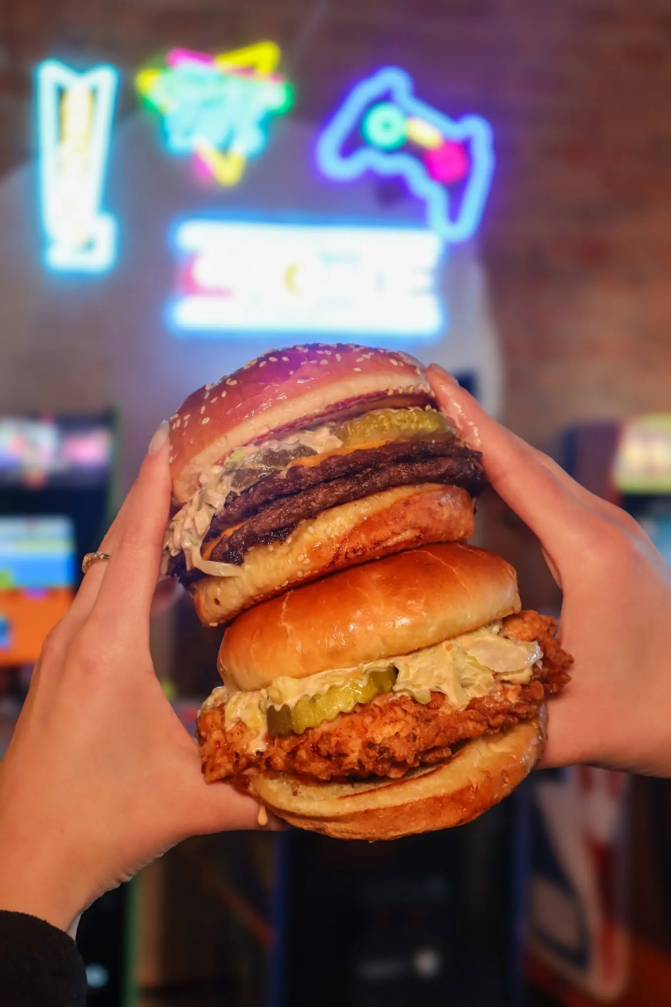 JoJo's Smash Burger and fried chicken sandwich held inside JoJo's ShakeBAR