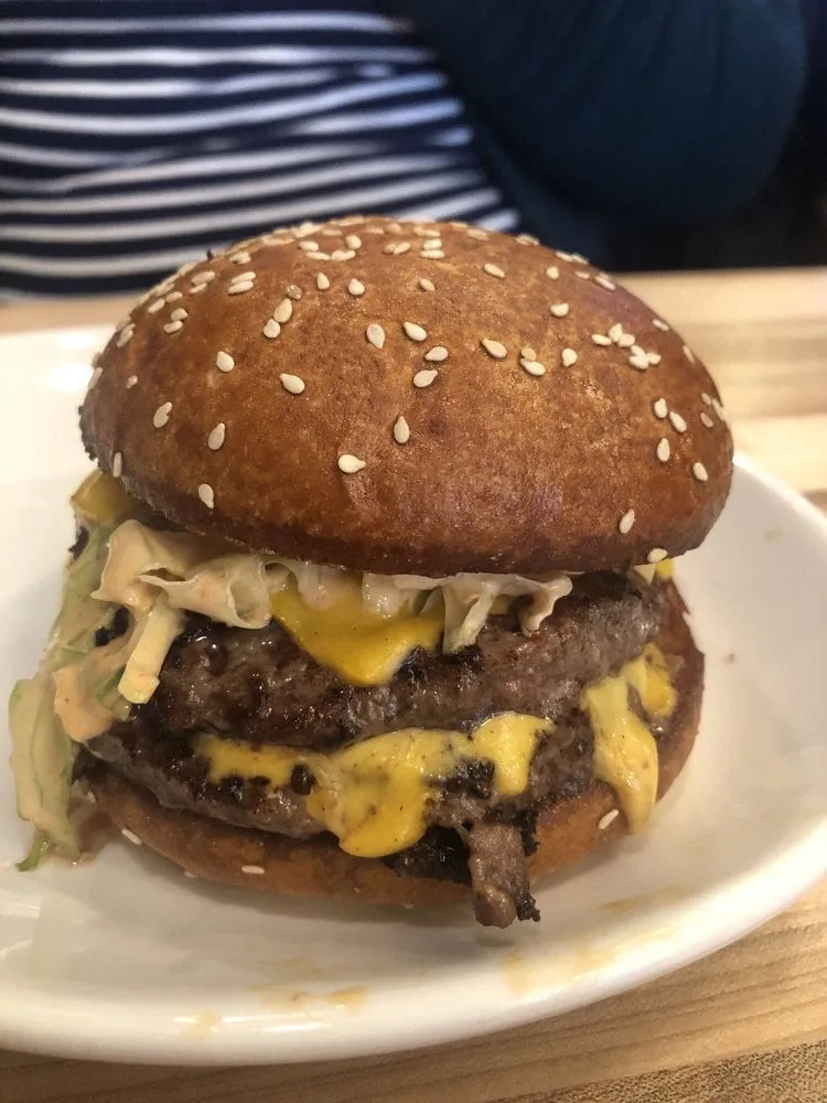 Double JoJo's Smash Burger with American cheese, lettuce, pickles, and Zip Sauce