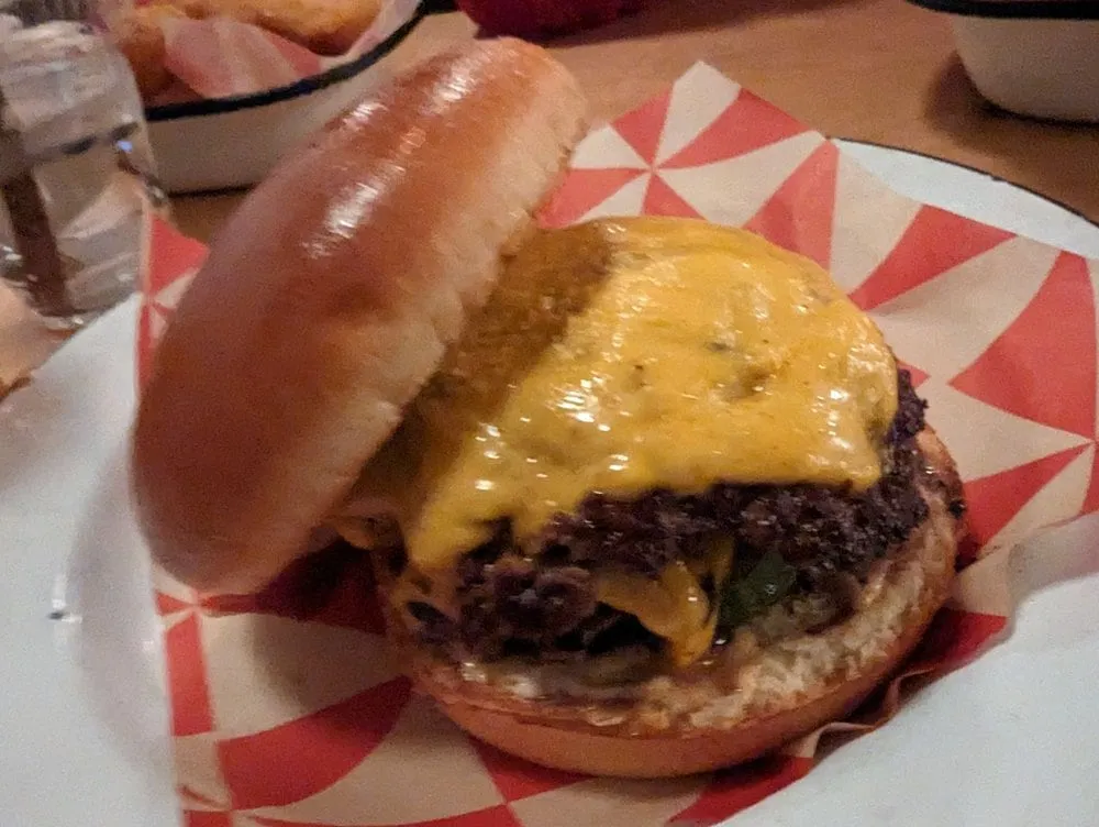Parson's double smash cheeseburger with pickles and sauce