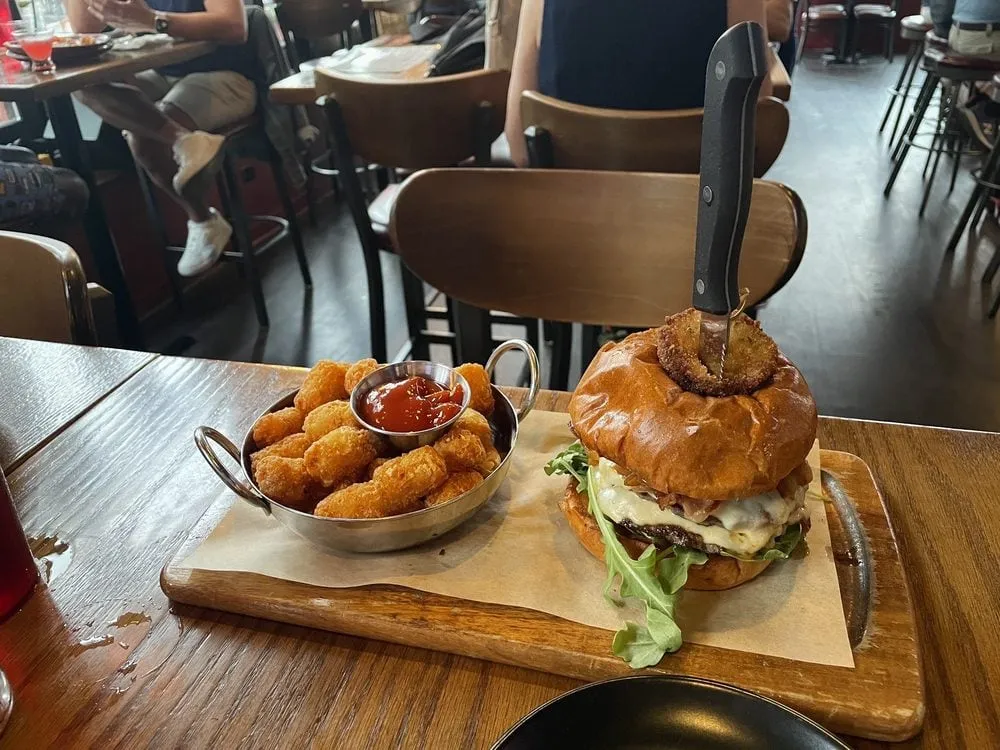 Replay Andersonville cheeseburger with a fried pickle and tater tots
