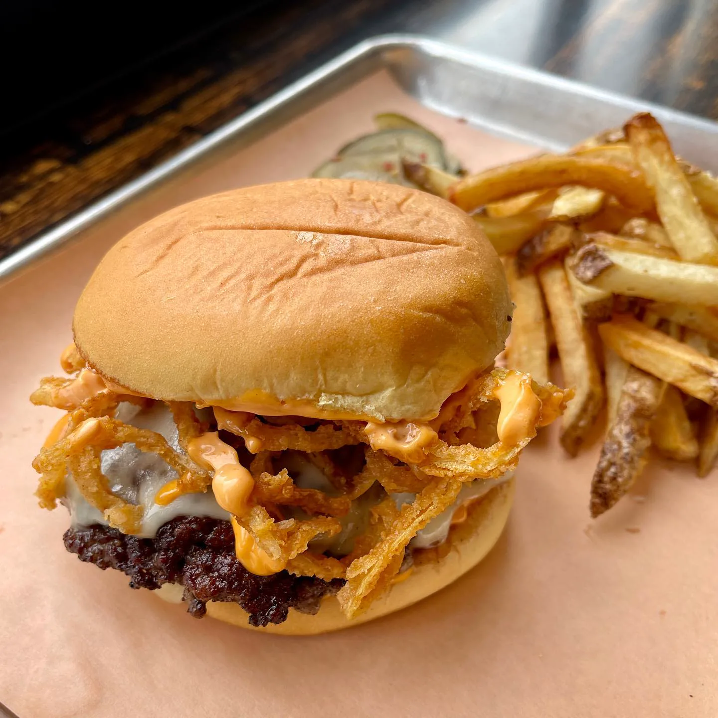 Pit & Tap burger close-up with melted cheese