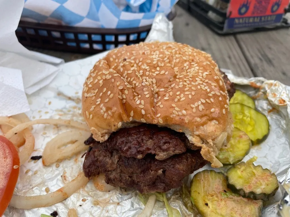 Sesame-bun smash burger with pickles at Natural State Provisions in Indianapolis