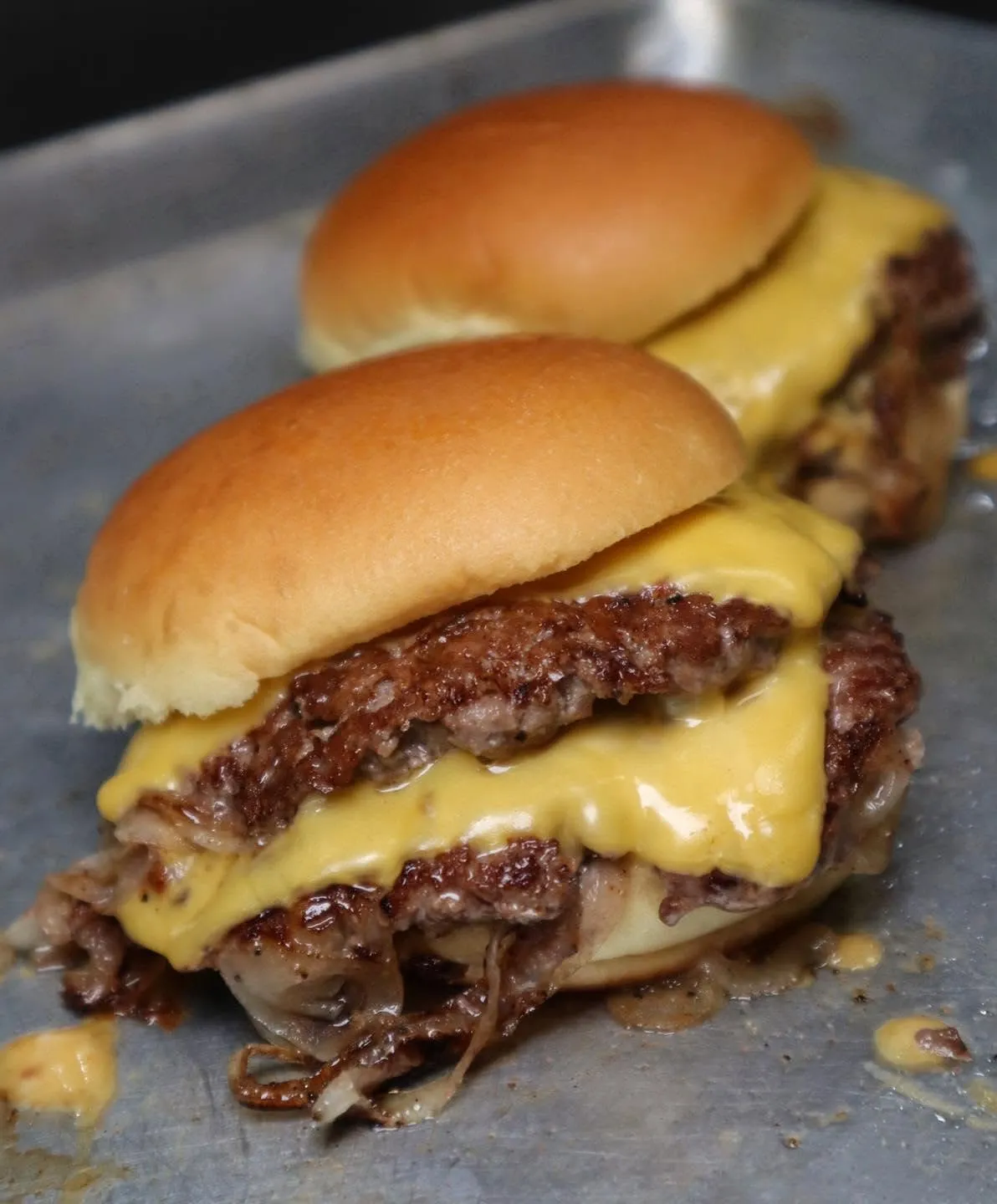 Two Eighty Twenty smashburgers with crisp beef edges, onions and American cheese