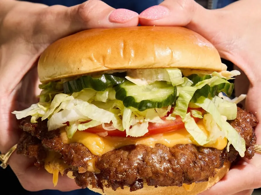 The Royale double smash burger at Harriet's Hamburgers  -  two smash patties with yellow American cheese, pickles, lettuce, tomato, and Good Good Sauce on French milk bread bun