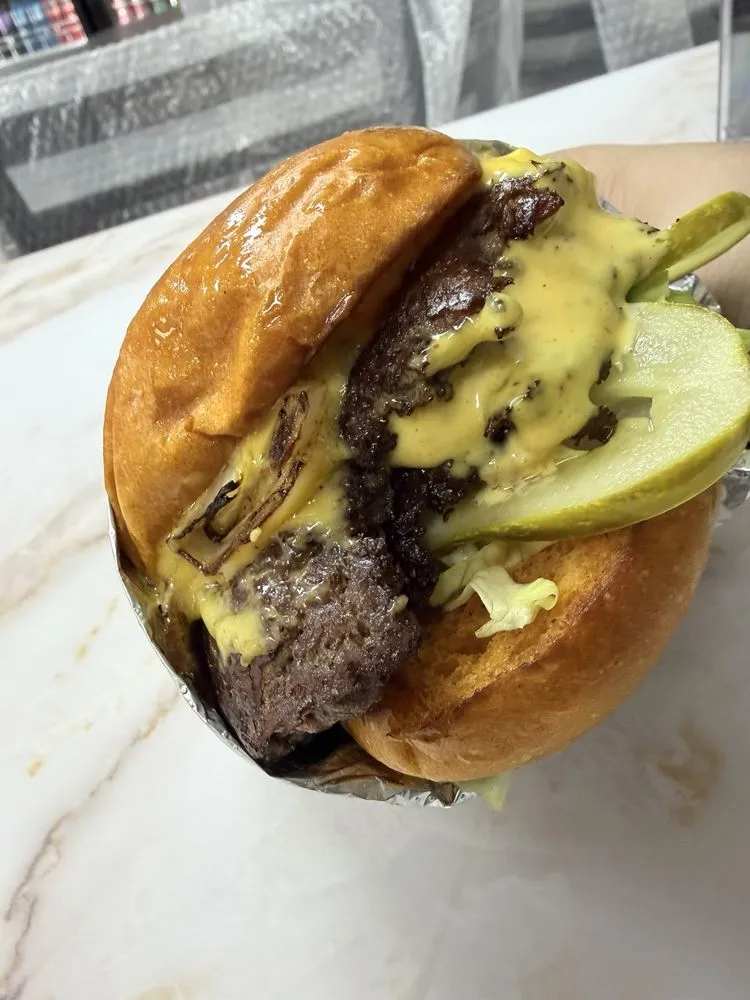 901 Smash Burgers double smashburger with cheese sauce and pickles