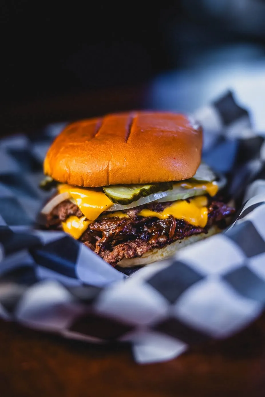 Roy's Tavern smashburger with crisp-edged patties, cheese, and pickles