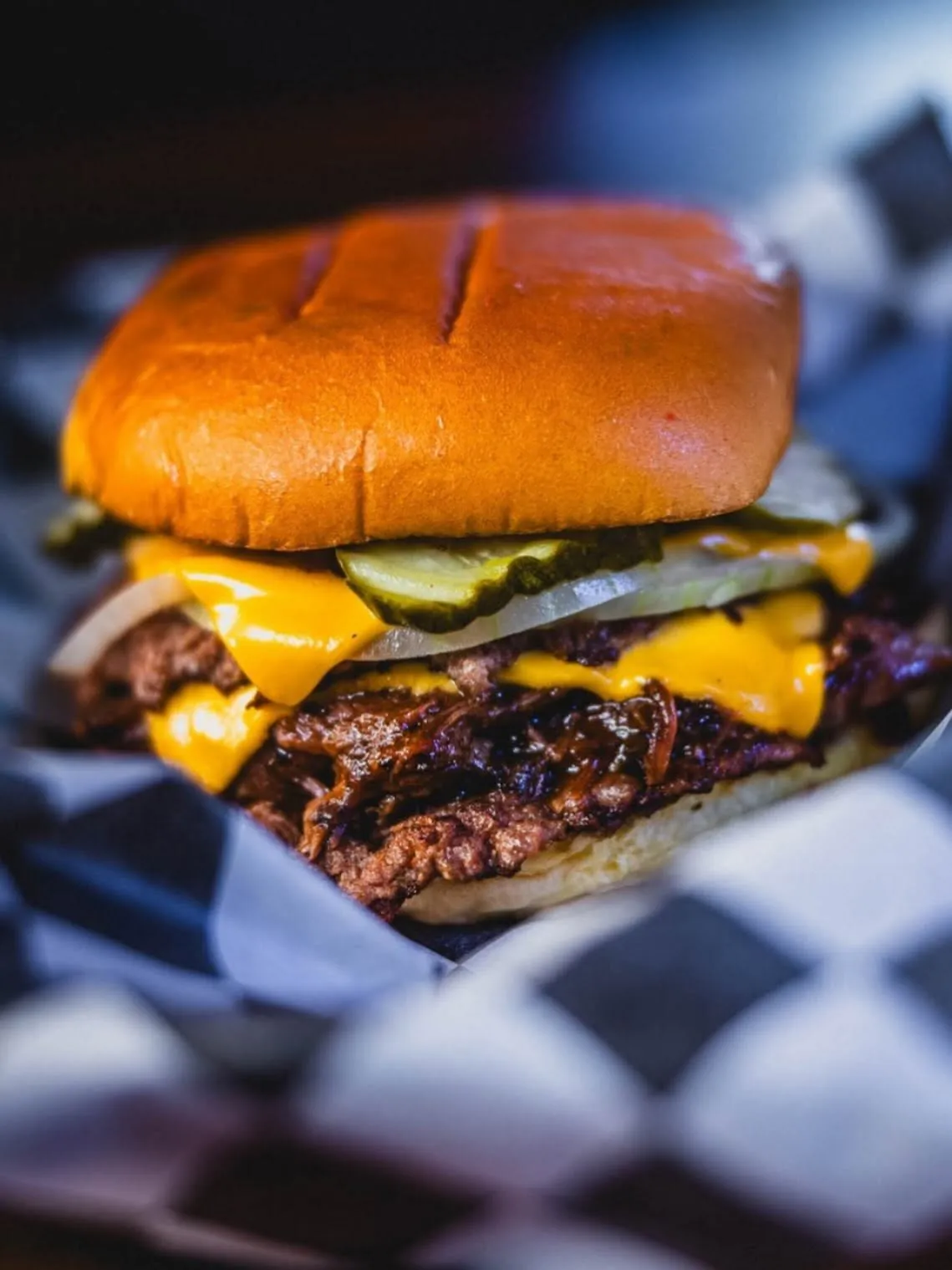 Close view of Roy's Tavern double smashburger with American cheese and pickles