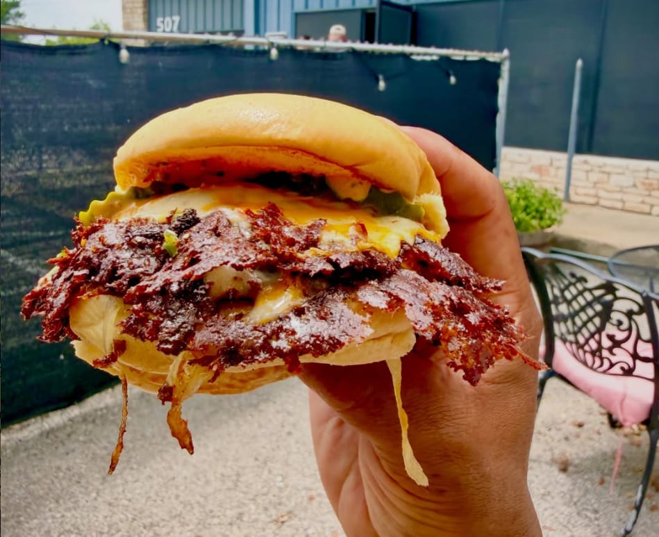 Handheld Lace Burgers smashburger with crisp wagyu edges and melted cheese