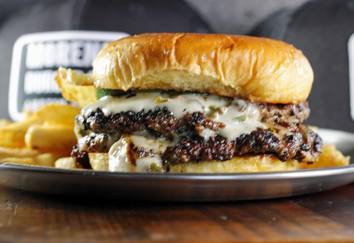 Moreno Burger Co. smashburger closeup with melted cheese and potato bun