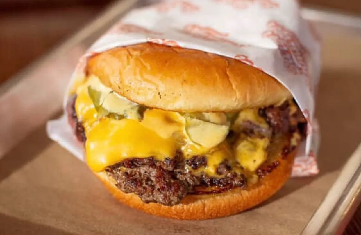 Interior of Burger Schmurger's East Dallas location on Buckner Blvd with mustard-yellow and sage-green checkered tile
